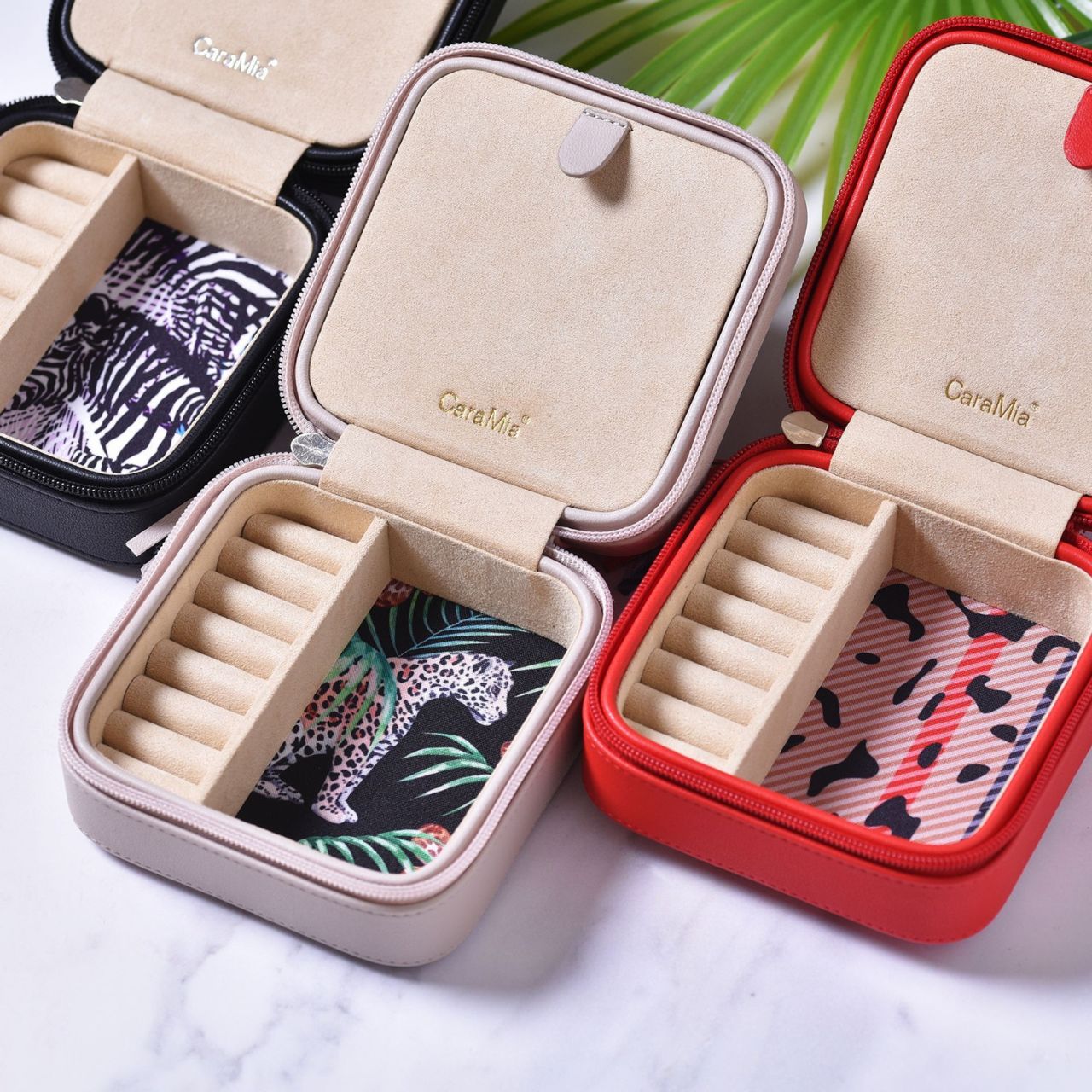 This striking jewellery case features a soft velvet interior with statement 'catchmere' panther print and matt cream, faux leather exterior.