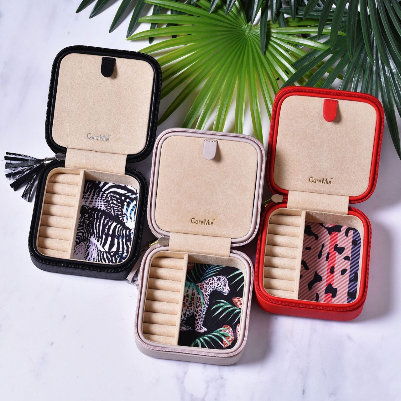 This striking jewellery case features a soft velvet interior with statement 'catwalk' print and matt red, faux leather exterior.