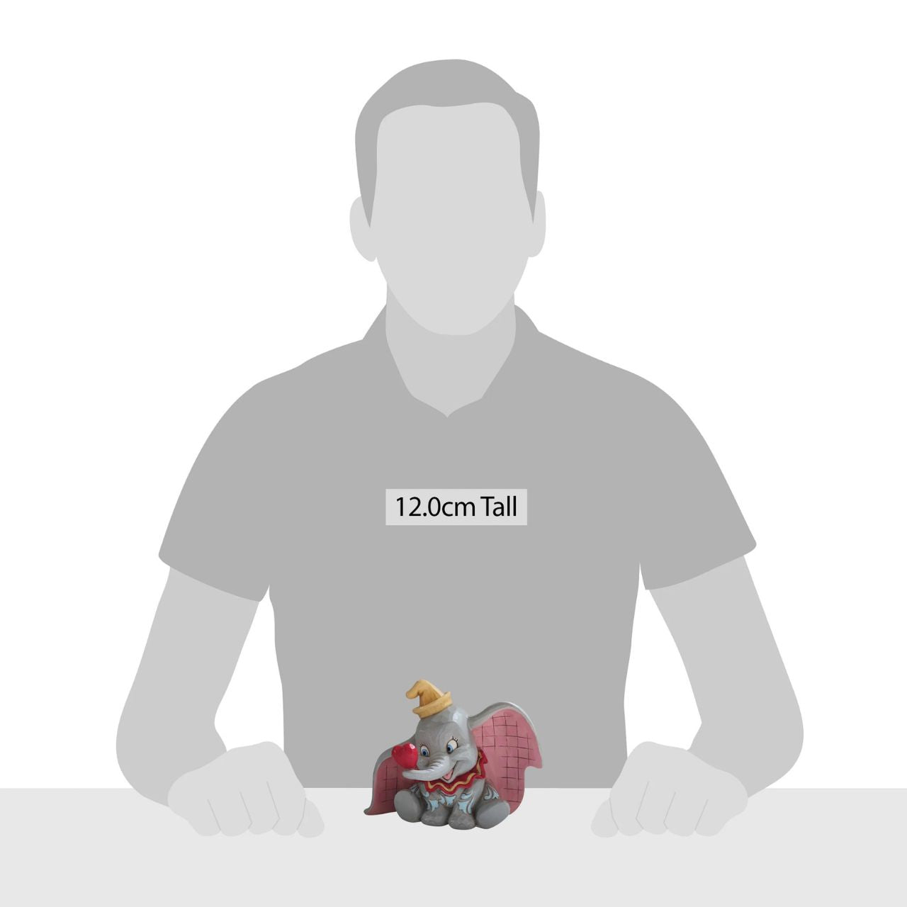 Disney Traditions A Gift of Love Dumbo with Heart Figurine "A Gift of Love" Holding a heart with his trunk, the lovable flying elephant, Dumbo, smiles sweetly in this charming creation by Jim Shore. With pretty patchwork on his ears and rosemaled design on his skin, Dumbo looks dashing in this simple and sentimental design.