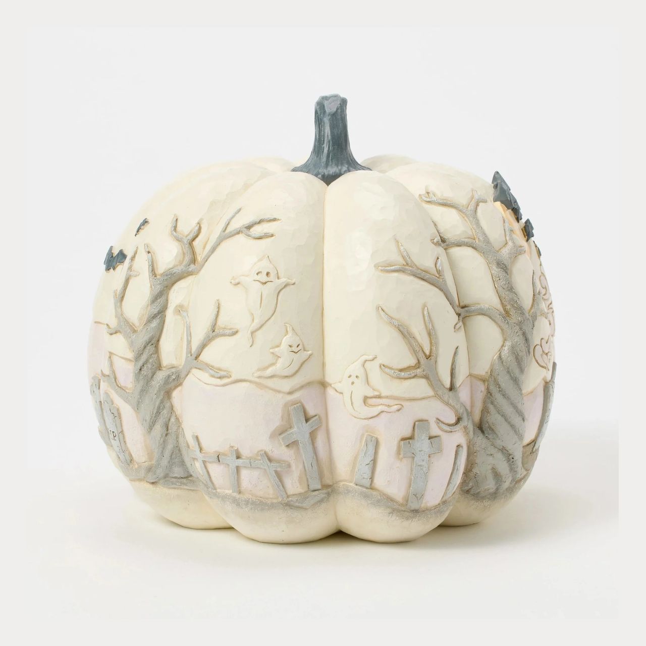 Capture the spirit of Halloween with this eerie Jim Shore pumpkin figurine, showcasing a haunted graveyard scene complete with a spooky haunted house, flying bats, and a full moon. With intricate details and haunting ambiance, prepare to scare.