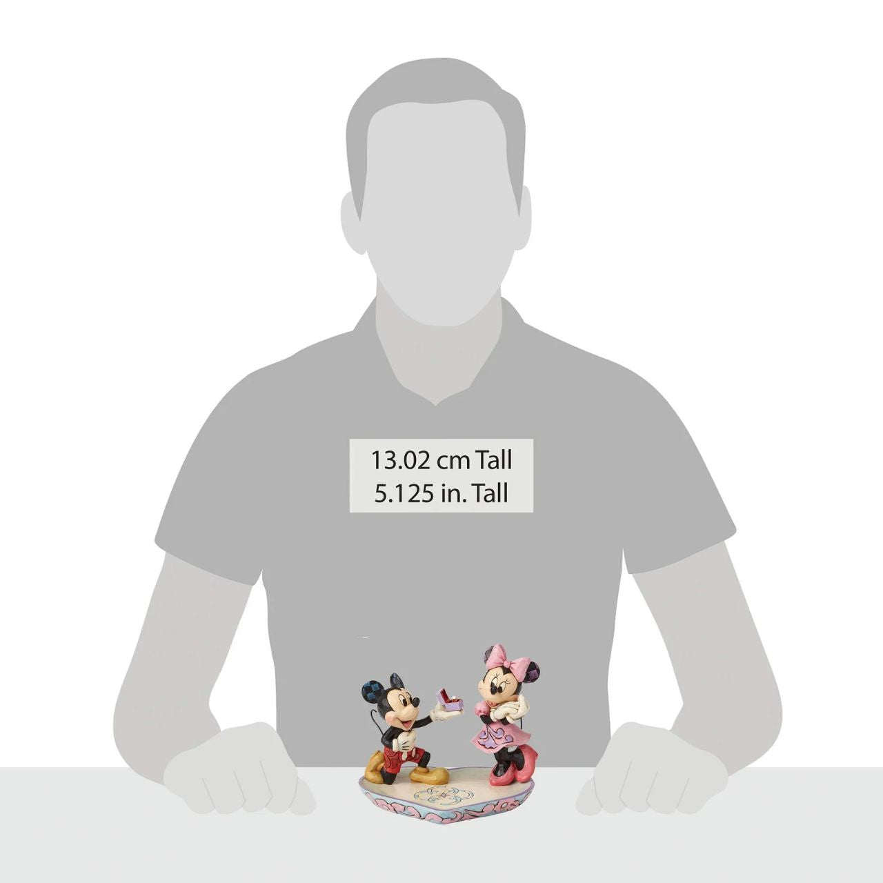 Mickey Mouse is the soul of romance as he proposes to a love-struck Minnie Mouse in this heartfelt design featuring the artistry of Jim Shore. The figurine is made from cast stone. It will also make a perfect ring tray for when you pop the question yourself or will add some Disney love to your own jewellery.