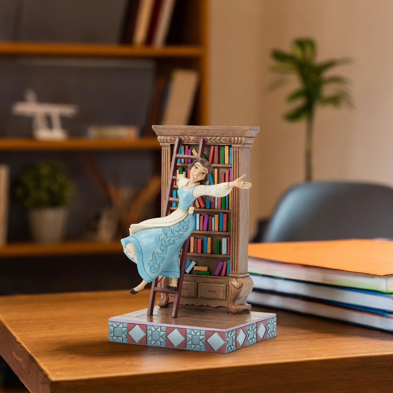 Celebrating the 35th anniversary of Beauty and the Beast in 2025, this lively Jim Shore scene captures Belle in her beloved library, singing as she glides gracefully on the bookshelf ladder. The gorgeous scene delights with exquisite rosemaling details.