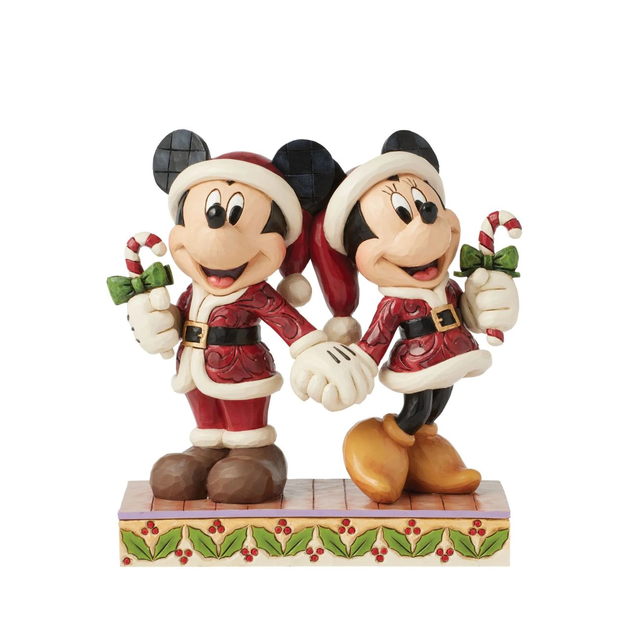 In this festive Jim Shore scene, Mickey and Minnie Mouse don Santa suits adorned with intricate rosemaling patterns and joyfully carry candy canes. Their bright smiles radiate holiday cheer, making the scene a delightful celebration of the season.