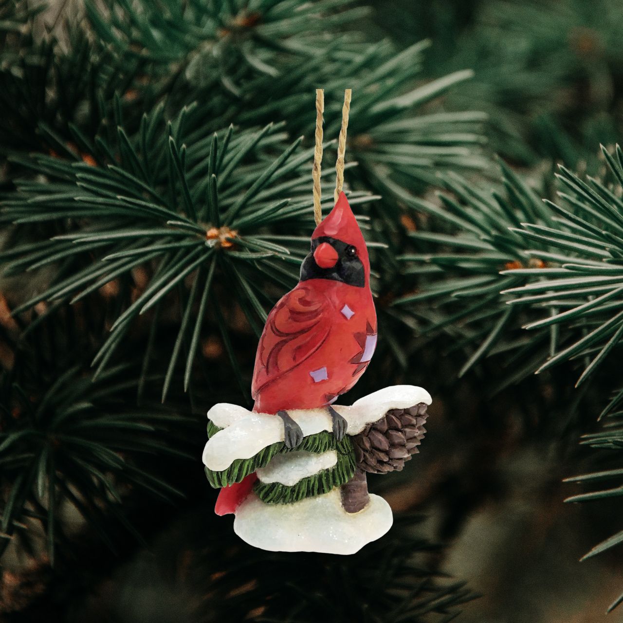 Carving Cardinal Hanging Ornament by Jim Shore  Celebrate Christmas with this beautiful hand crafted and hand painted Carving Cardinal on Snowy Branch Hanging Ornament. Decorate your tree this Christmas with this Carving Cardinal on Snowy Branch Hanging Ornament.