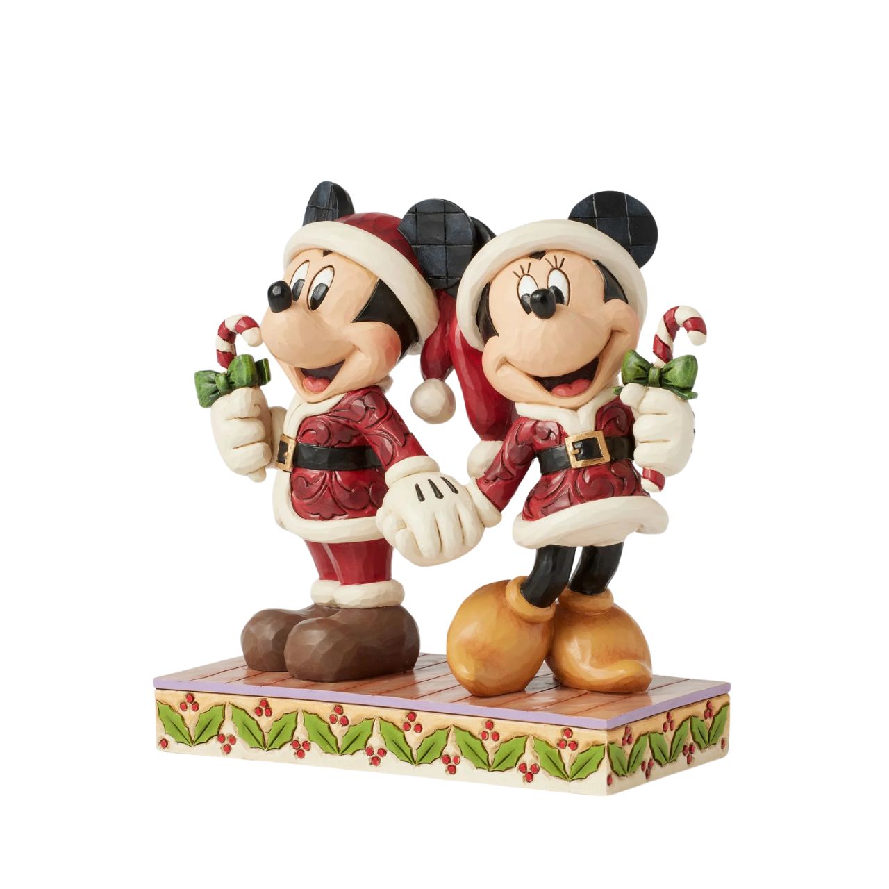 In this festive Jim Shore scene, Mickey and Minnie Mouse don Santa suits adorned with intricate rosemaling patterns and joyfully carry candy canes. Their bright smiles radiate holiday cheer, making the scene a delightful celebration of the season.