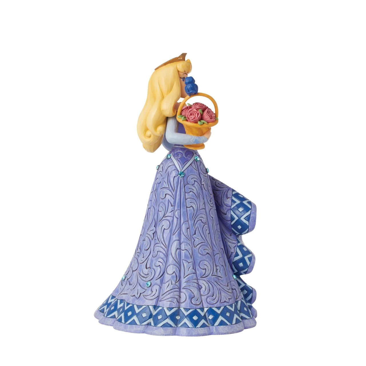 Introducing the Deluxe Aurora Figurine from Disney Traditions by Jim Shore. This exquisite piece depicts Sleeping Beauty Aurora in a beautiful, blue dress, accessorized with a stunning crown, carrying a basket of pink roses with a small bluebird perched on top.