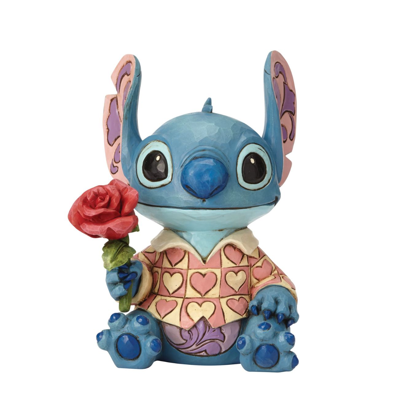 Jim Shore Clueless Casanova Stitch Figurine Stitch has transformed into a model citizen that Lilo would be proud of! Designed by Jim Shore, the adorable alien wears a heart-patterned shirt as he offers a single red rose. Stitch makes a great gift for your Ohana.