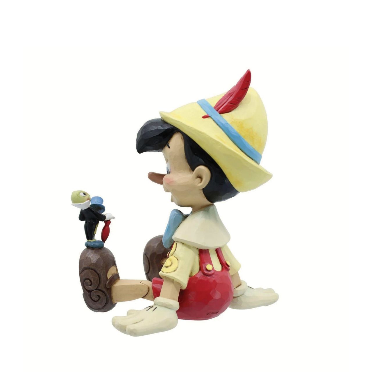 Pinocchio and Jiminy Sitting Figurine by Jim Shore "Wishful and Wise" Jiminy Cricket is quite the dapper conscience in this design by Jim Shore, giving a tip o' his top hat as he smiles and gives his bestie Pinocchio a lesson about temptations.
