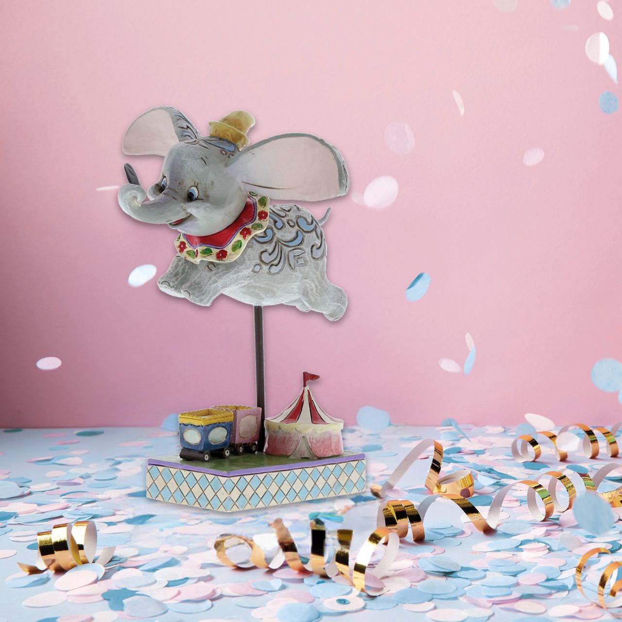 Disney Traditions combines the magic of Disney with the American folk artistry of Jim Shore. Enjoy this wonderful figurine of beloved Dumbo as he takes his first flight with the help of a magical feather.