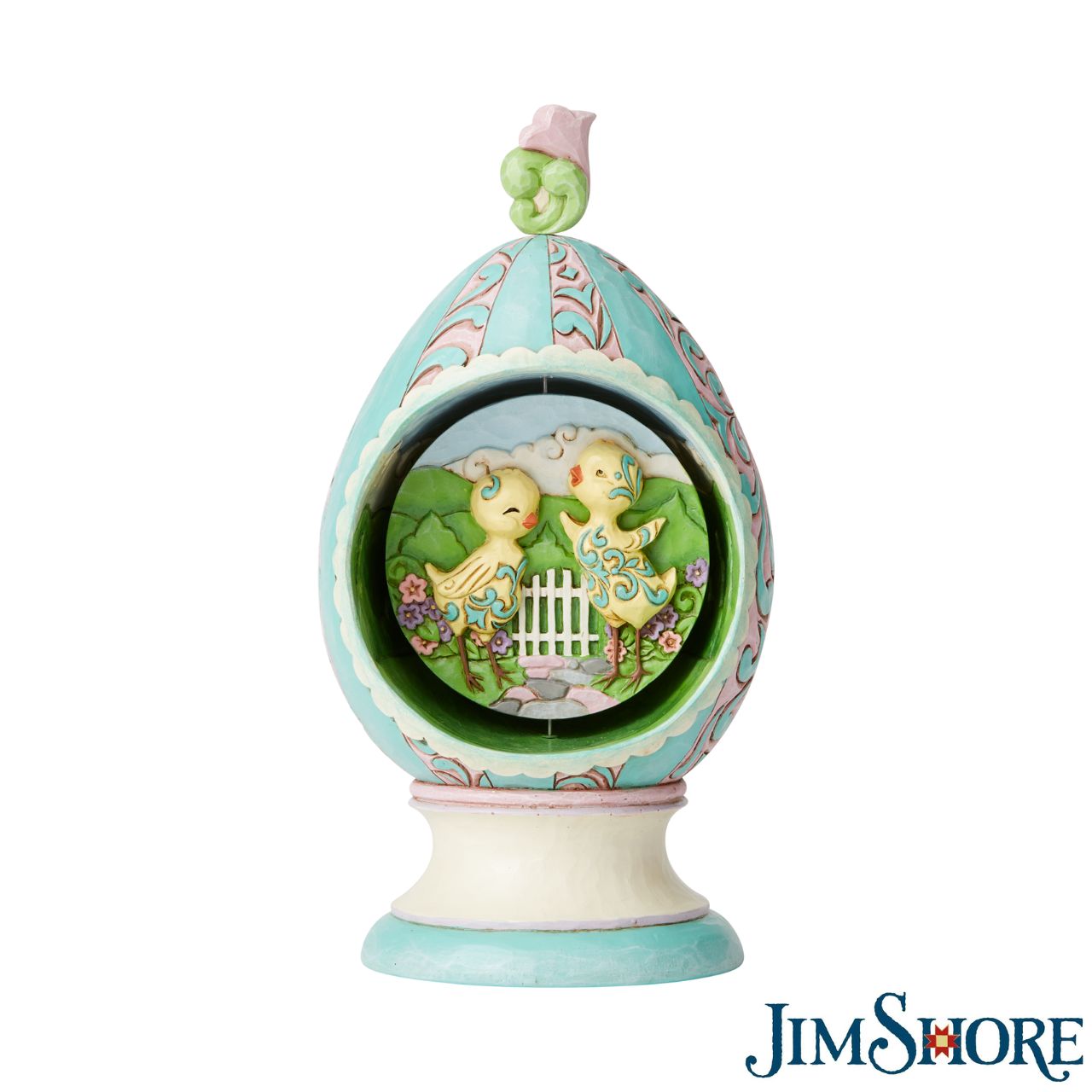 Revolving Egg with Bunnies and Chicks Scene Figurine by Jim Shore Stroll through Spring with this festive Jim Shore tabletop Easter egg. Simply turn the floral finial atop the egg to rotate the scene inside between two adorable Easter scenes. Chicks soak in the sun while a pair of bunnies jubilantly collect eggs.