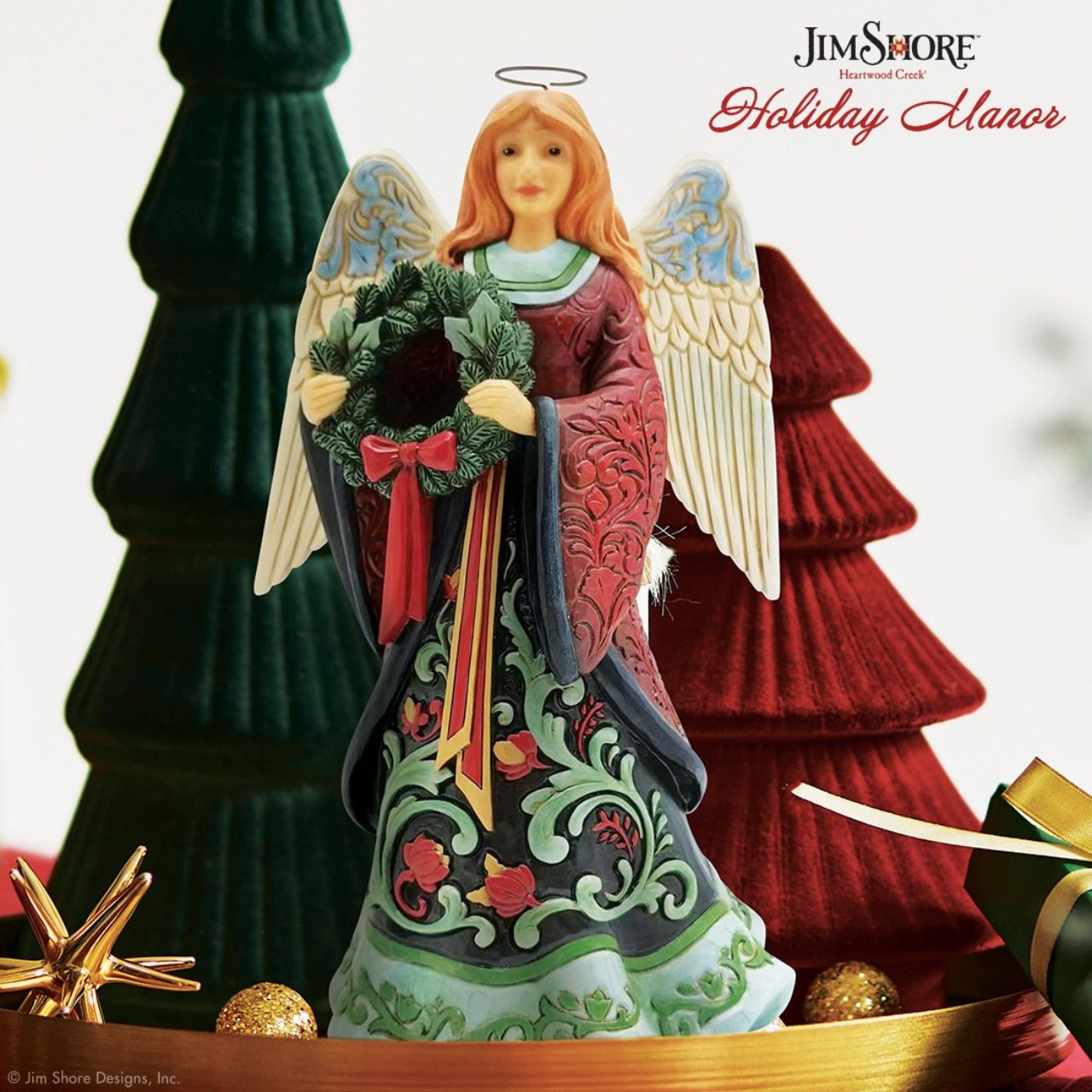 Heartwood Creek Holiday Manor Christmas Angel Figurine Designed by award winning artist Jim Shore as part of the Heartwood Creek Holiday Manor Collection, hand crafted using high quality cast stone and hand painted, this festive Angel is perfect for the Christmas season.