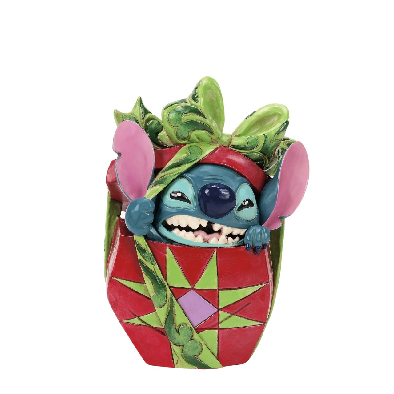 In this playful Jim Shore design, Stitch the alien bursts out of a vibrant Christmas present, showcasing his mischievous grin as he tears through festive wrapping. With his joyful chaos, Stitch proves that his lively presence is the best gift of all.