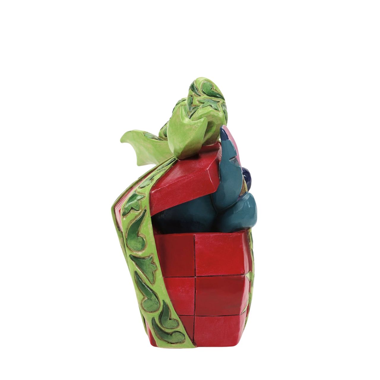 In this playful Jim Shore design, Stitch the alien bursts out of a vibrant Christmas present, showcasing his mischievous grin as he tears through festive wrapping. With his joyful chaos, Stitch proves that his lively presence is the best gift of all.