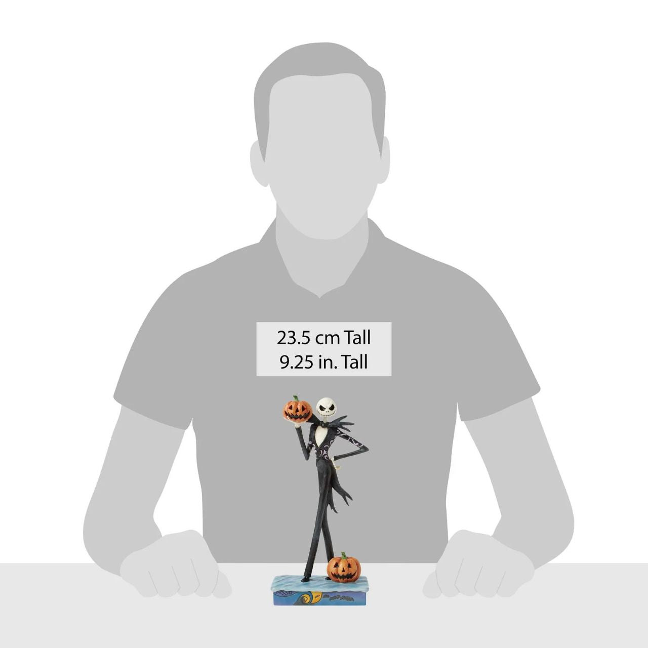 In this captivating Jim Shore design, Jack Skellington, clad in a striking black and white suit, exudes charm with a mischievous grin as he holds a Jack-o-lantern. Bring home Jim's newest The Nightmare Before Christmas designs.