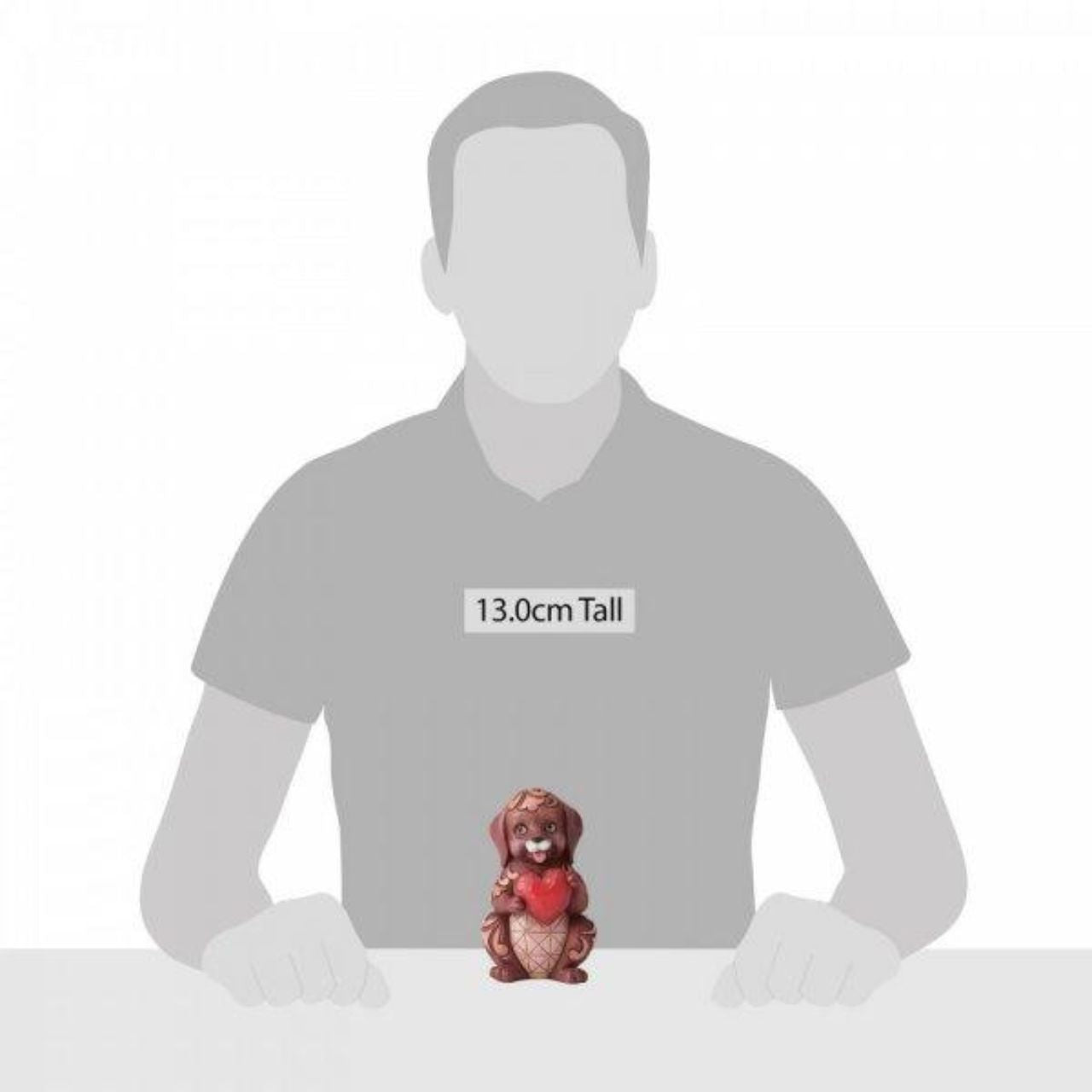 Love Is A Faithful Friend Dog Holding Heart Pint-Sized Love is what keeps us smiling. This amorous Jim Shore puppy holds a crimson heart in its paws with a bright grin upon its face, confident to bring one to your own.