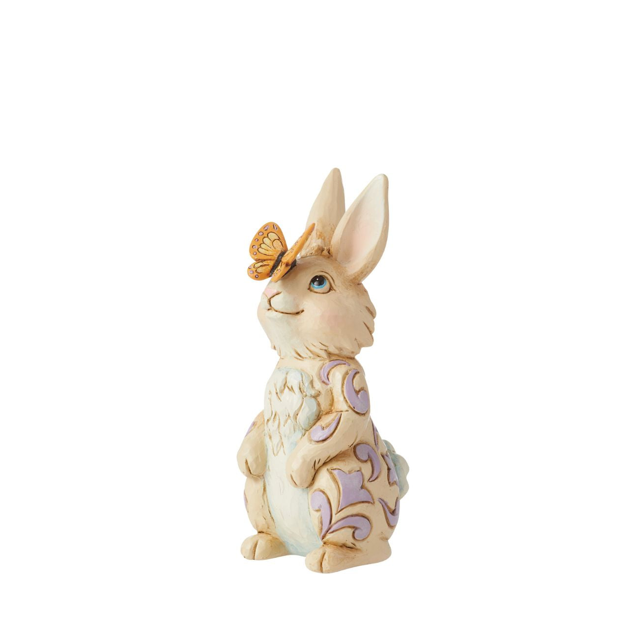 Enchanted by a butterfly resting on its nose, this adorable mini bunny stands tall with gentle sincerity. With delicate purple rosemaling on his fur, this Jim Shore rabbit figurine is sure to inspire smiles this Spring.