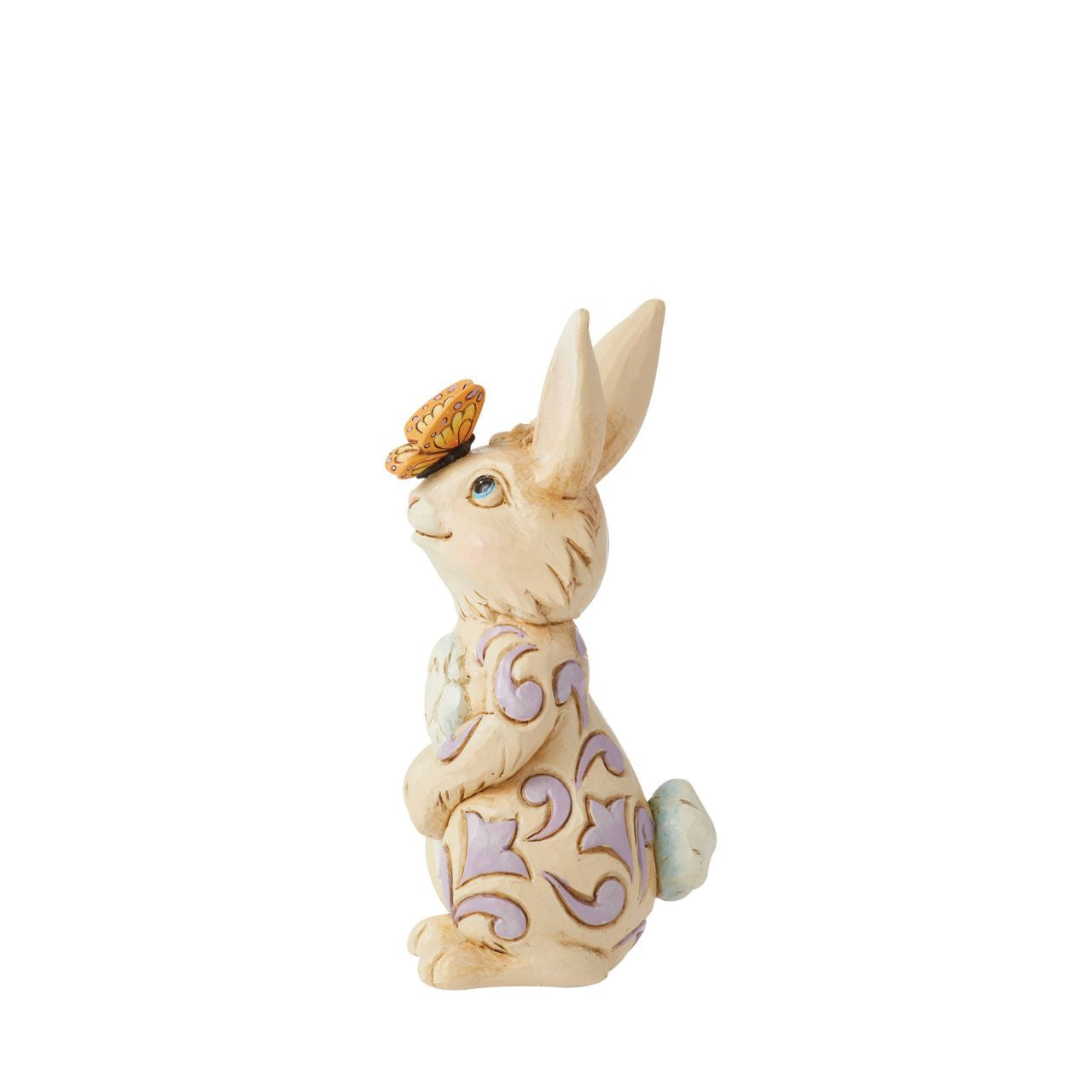 Enchanted by a butterfly resting on its nose, this adorable mini bunny stands tall with gentle sincerity. With delicate purple rosemaling on his fur, this Jim Shore rabbit figurine is sure to inspire smiles this Spring.