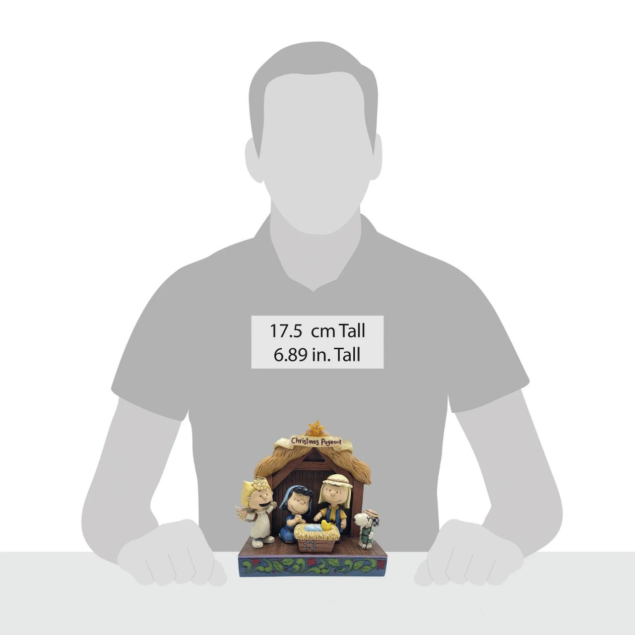 Jim Shore invites you to the Peanuts Christmas pageant! On a rosemale stage, Lucy and Linus sit in a manger dressed as Mary and Joseph tending to a Woodstock baby Jesus. Sally is dressed as an angel and Snoopy is a shepherd.