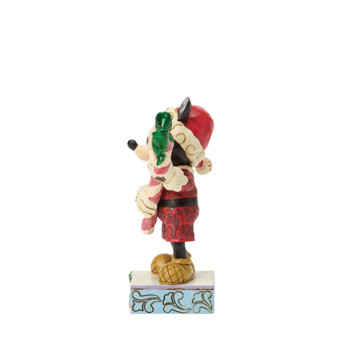 Mickey holds a giant candy cane in this festive Jim Shore design. With a playful pose, Mickey is dressed in a Santa hat and red coat with rosemaling details, he adds a touch of holiday sweetness and Disney magic to your Christmas traditions.