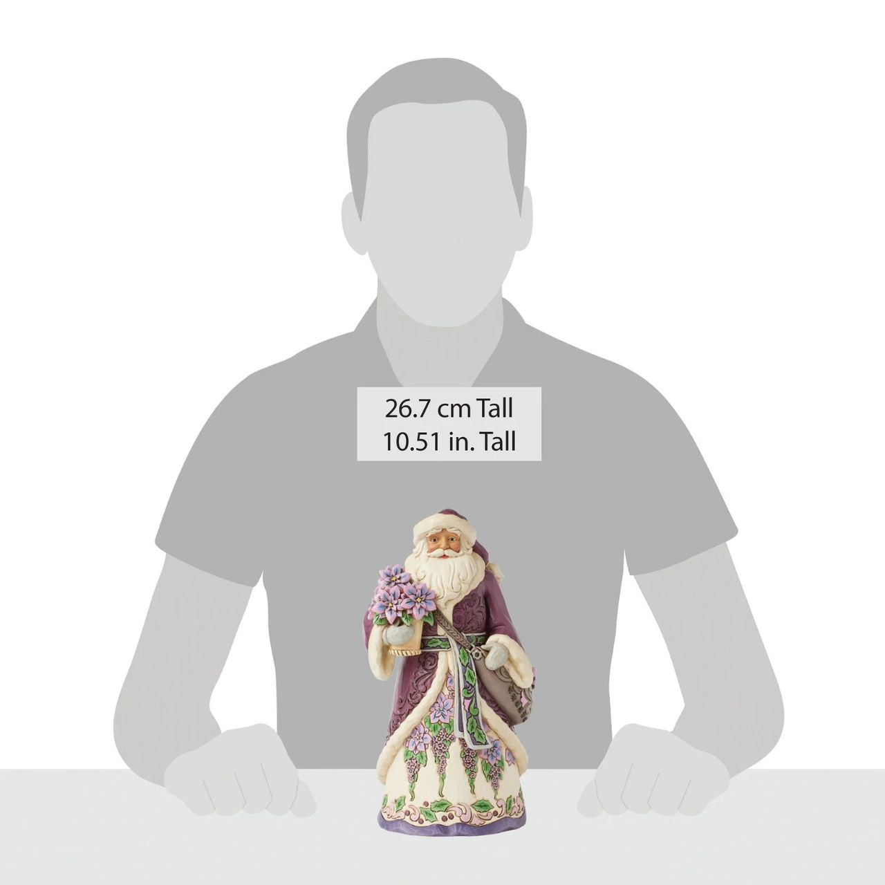 The stunning purple Santa representing Jim Shores trademark colour. Radiating elegance in rich purples, plums, and greens, carrying a vibrant purple poinsettias. His intricately detailed cloak features delicate rosemaling, while his robes bloom with festivities.