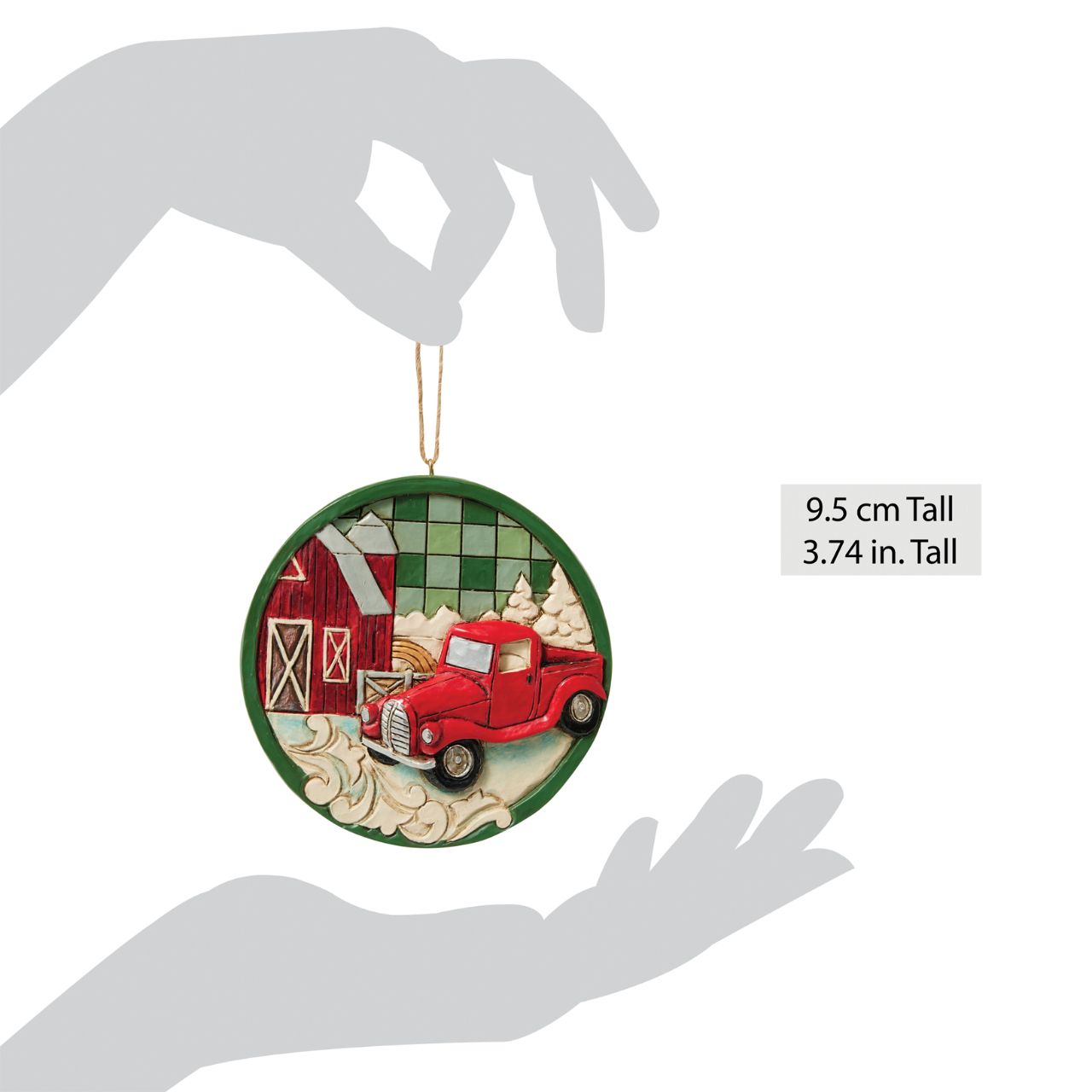 This charming Jim Shore Highland Glen ornament showcases a cozy farm scene with a classic red pickup truck surrounded by lush pines, all set against a green plaid background. This festive piece shares a calming sense of rural holiday charm.