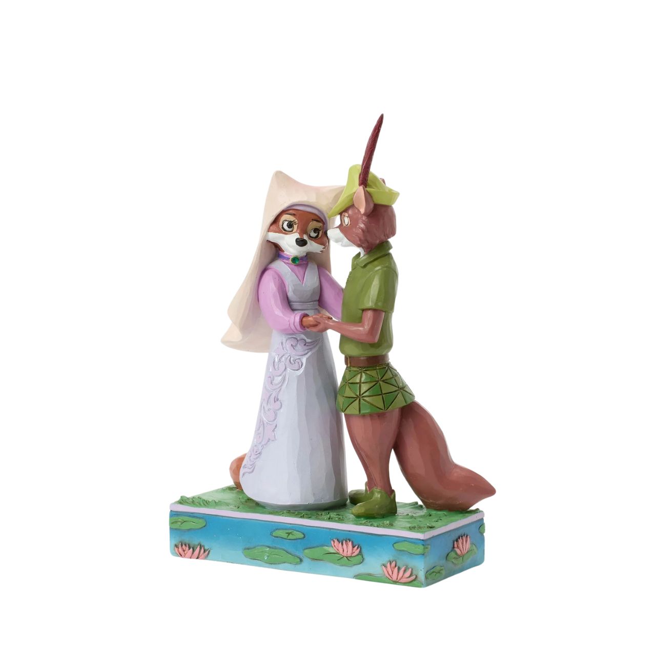 This Jim Shore rendition of Robin Hood and Maid Marian stand hand in hand, gazing into each other's eyes. Adorned with the artist's signature patchwork and rosemaling details, the piece captures the romance and adventure of their timeless story.