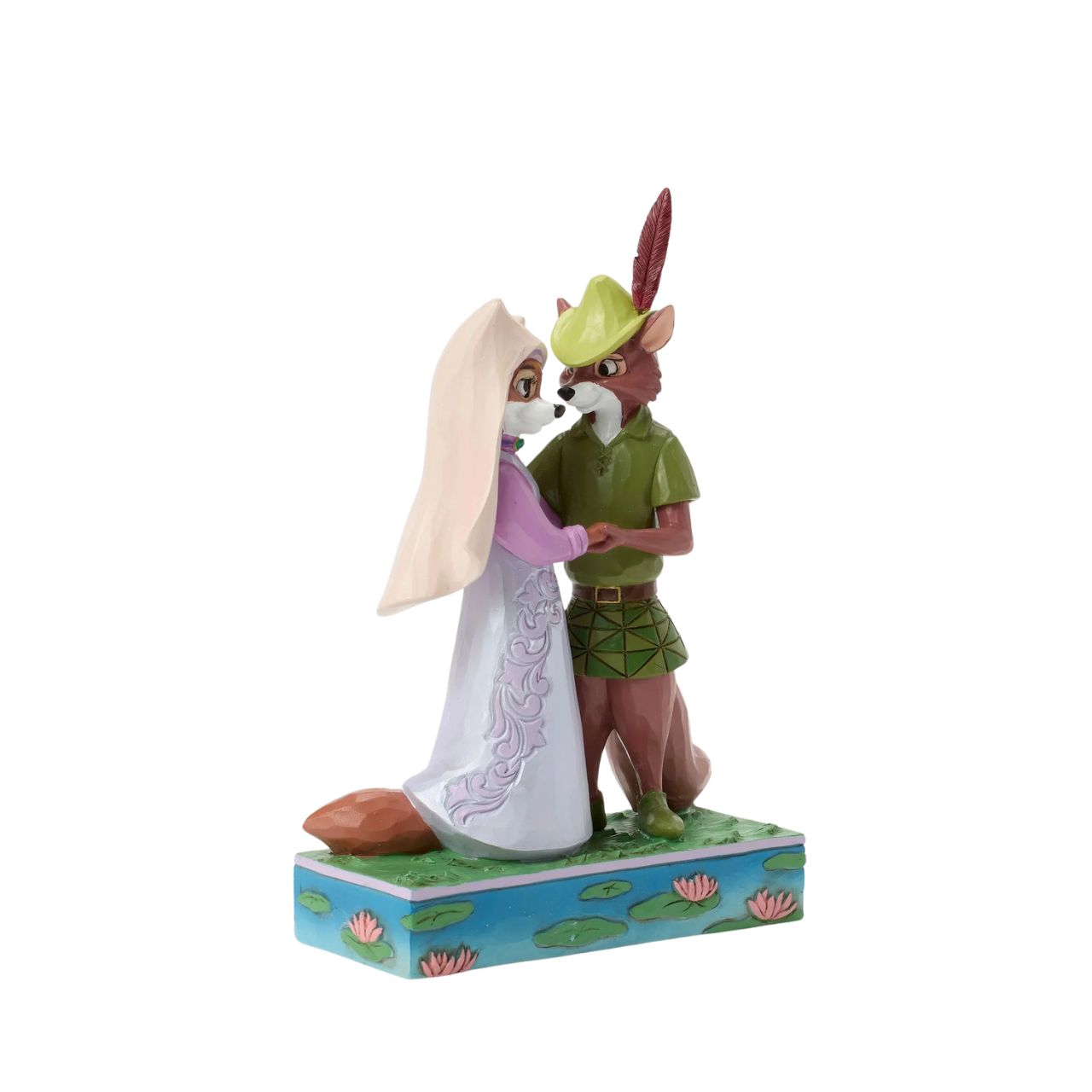 This Jim Shore rendition of Robin Hood and Maid Marian stand hand in hand, gazing into each other's eyes. Adorned with the artist's signature patchwork and rosemaling details, the piece captures the romance and adventure of their timeless story.