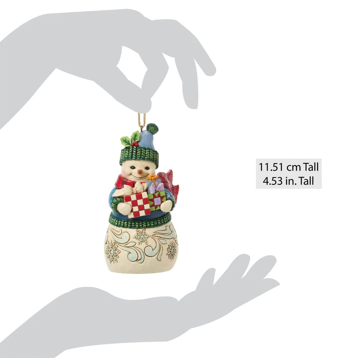 Celebrate the magic of Christmas with this delightful Snowman Figurine from Heartwood Creek by Jim Shore. This endearing snowman is depicted carrying an abundance of holiday treasures, showcasing Jim Shore's signature folk-art style with intricate patterns and a warm colour palette.