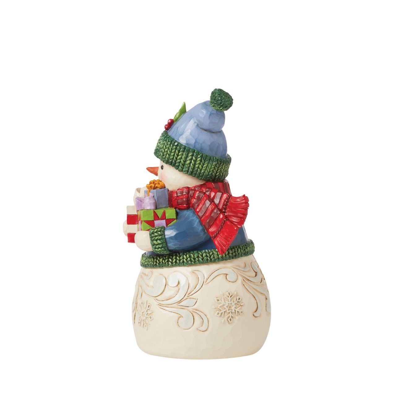This charming snowman figurine by Jim Shore inspires holiday happiness. Keeping warm wearing a knitted sweater, holly trim hat, and billowing red scarf this snowman boasts rosy cheeks in the chilled air. He smiles with arms full.