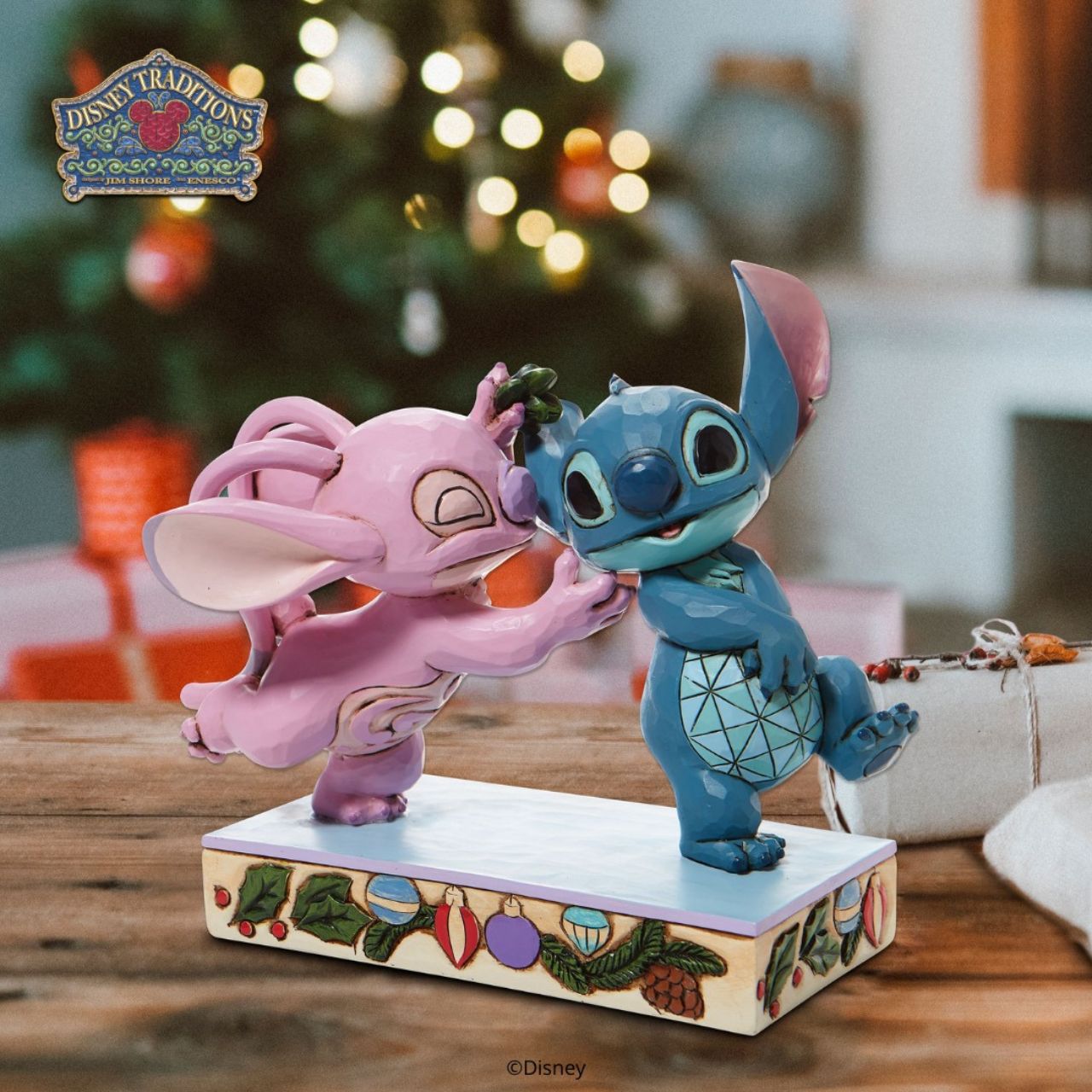 Disney Stitch and Angel with Mistletoe Figurine - Mistletoe Kiss Stitch the holiday hooligan meets his match under the mistletoe this season. The pair of mischievous aliens share a smooch in this sweet Jim Shore figurine. Colourfully lined in ornaments, the pair make a lovely addition to any home - even on Earth.