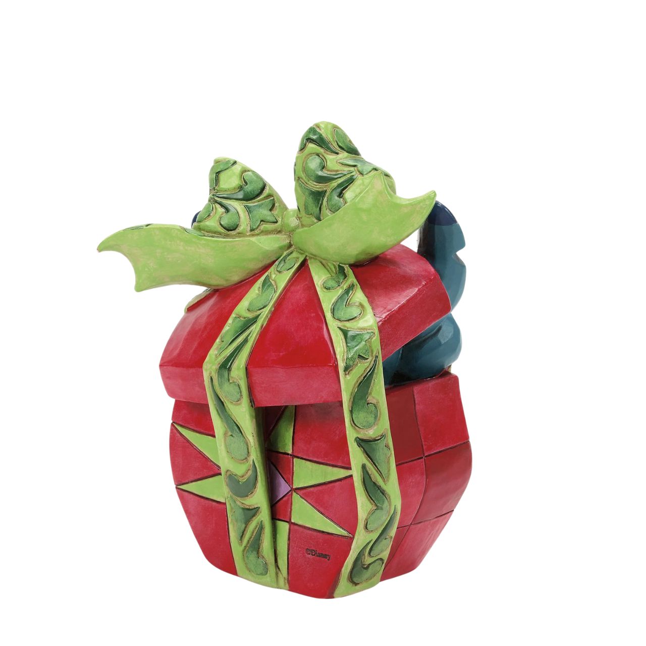 In this playful Jim Shore design, Stitch the alien bursts out of a vibrant Christmas present, showcasing his mischievous grin as he tears through festive wrapping. With his joyful chaos, Stitch proves that his lively presence is the best gift of all.