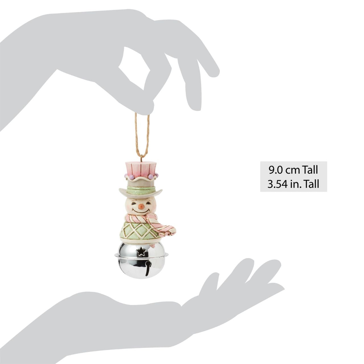 This delightful Jim Shore Heartwood Sweets jingle bell ornament features a charming miniature bust of a snowman, smiling in pastel decor, his vest is decorated with festive gumdrops. Ring in the season with Jim Shore.