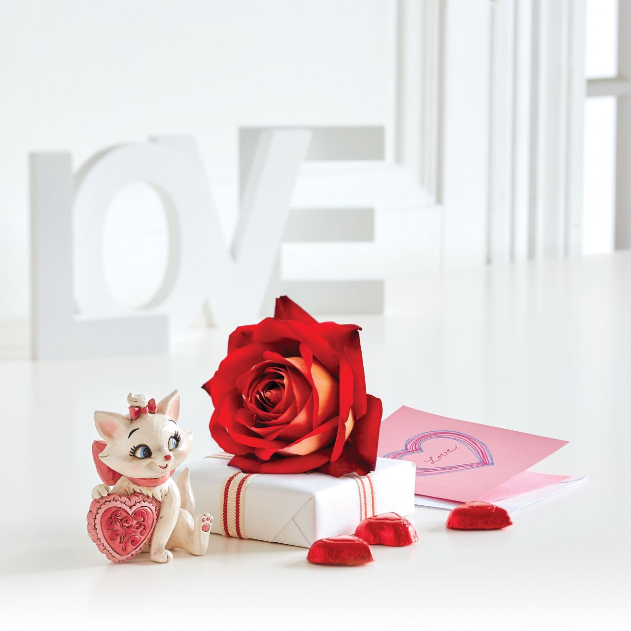 Disney The Aristocats Marie Heart Mini Figurine The 1970 Walt Disney classic, The Aristocats, followed three kittens and their mother across the Parisian countryside after being cat-napped from their home. Marie, the only daughter of the bunch, holds a pink heart in this sweet Jim Shore figurine. Packaged in a branded gift box.