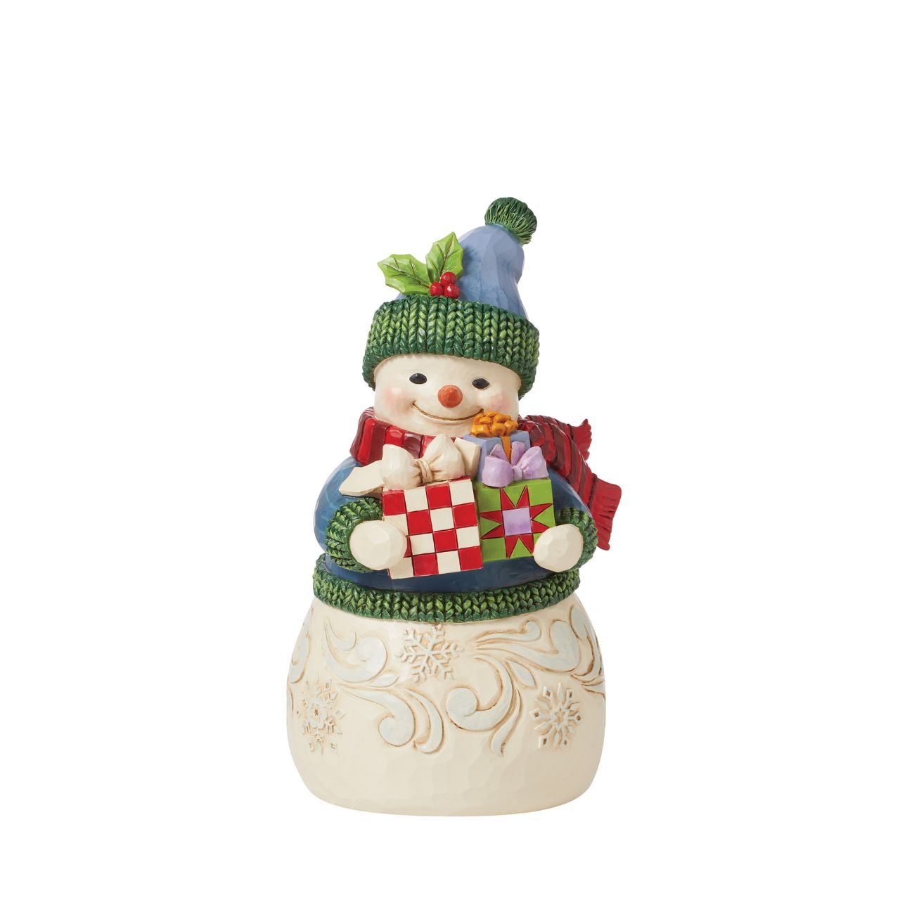 This charming snowman figurine by Jim Shore inspires holiday happiness. Keeping warm wearing a knitted sweater, holly trim hat, and billowing red scarf this snowman boasts rosy cheeks in the chilled air. He smiles with arms full.