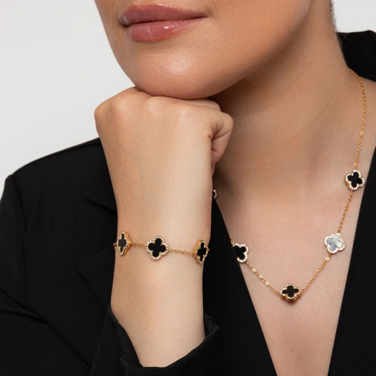 Five clover elements with black resin & crystal on fine gold plated chain. Lobster claw fastening.