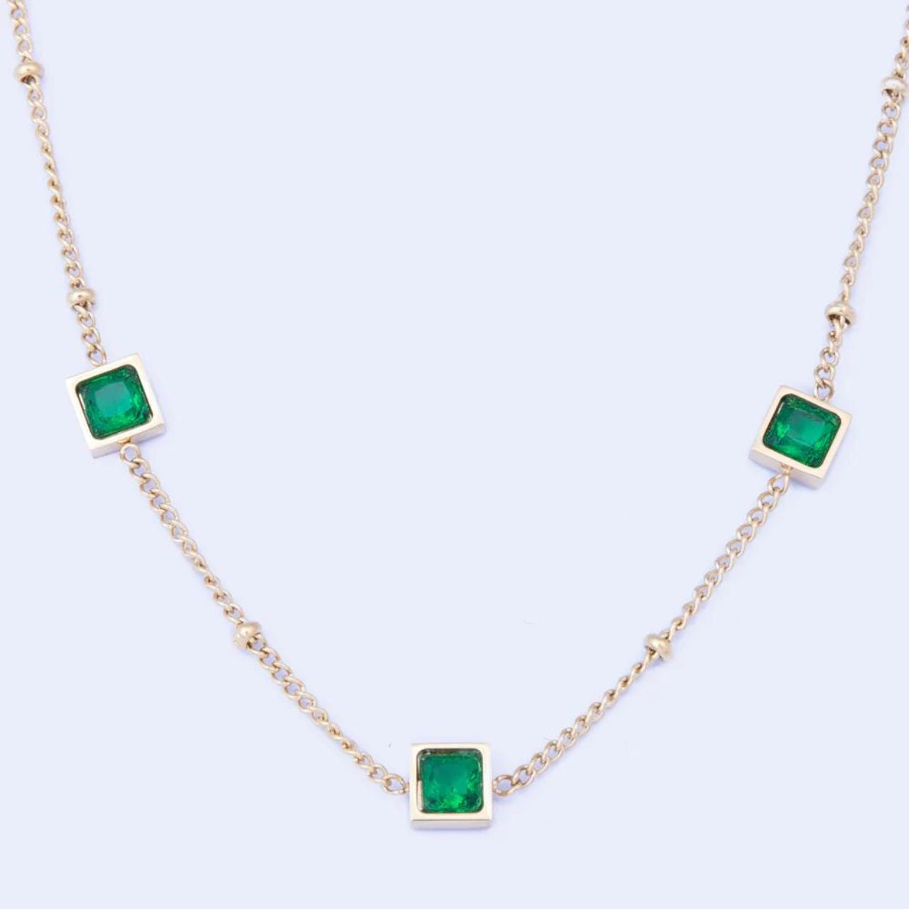 Leilani Emerald Necklace by Knight & Day The Knight & Day Leilani Emerald Necklace is plated with luxurious 14K yellow gold for a stylish yet timeless look. The lustrous green stones provide a radiant contrast and create a striking statement piece.