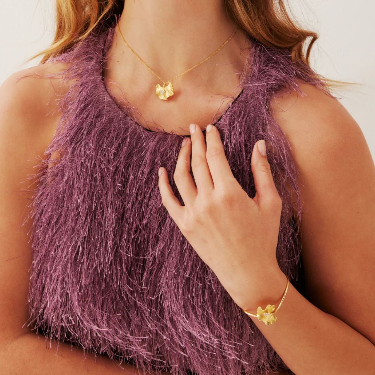 The Ophelia Gold Pendant Necklace features a delicate petal-inspired design centred with a sparkling cubic zirconia (CZ) stone, creating a timeless piece that adds effortless elegance to any outfit.