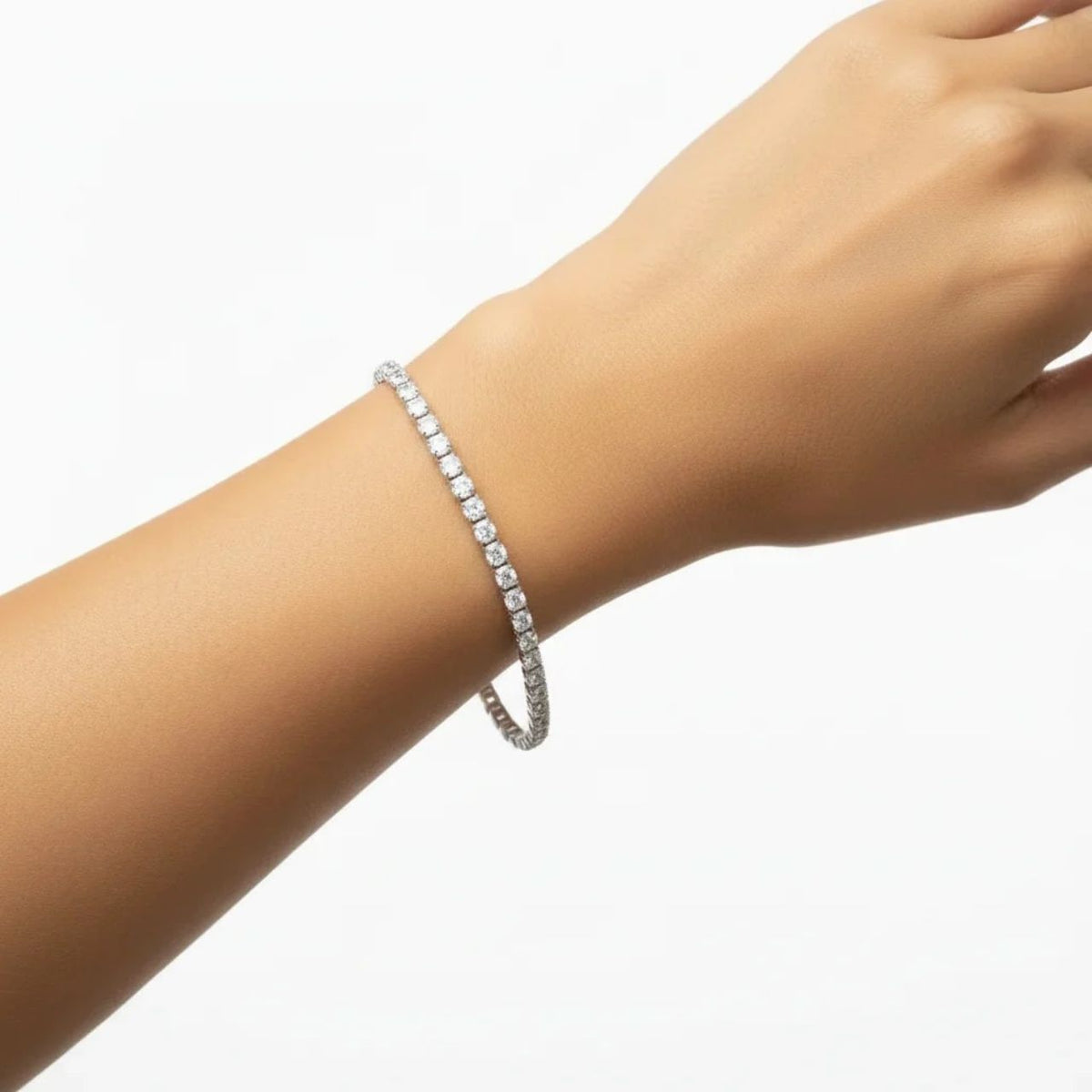 Elegant tennis bracelet by Knight & Day, featuring a continuous line of sparkling 4mm cubic zirconia stones. The rhodium-plated design offers a luxurious silver-tone finish that resists tarnishing, while the secure fold-over clasp ensures your bracelet stays perfectly in place.