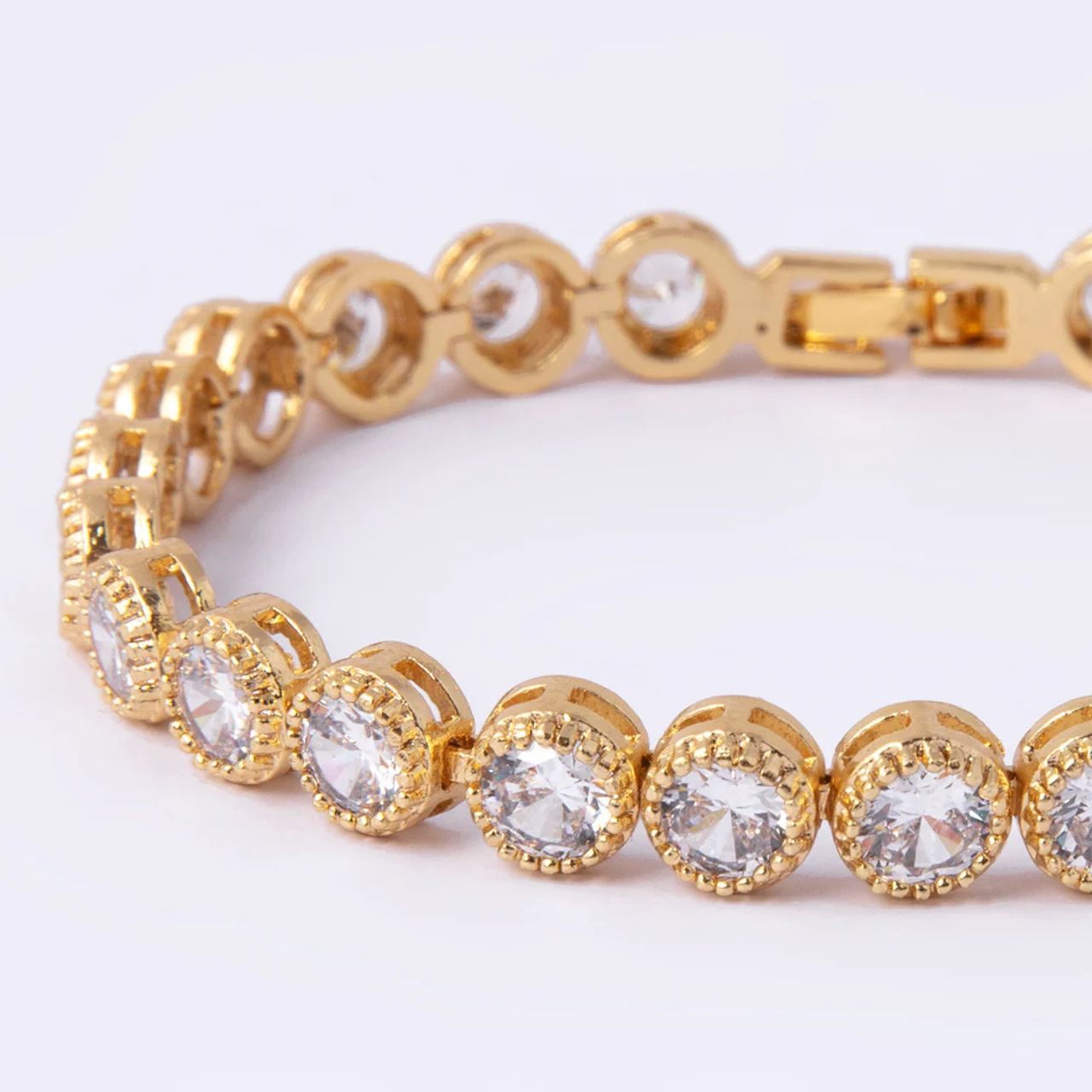 Beautiful gold plated tennis bracelet with CZ stones. Fold over clasp fastening.