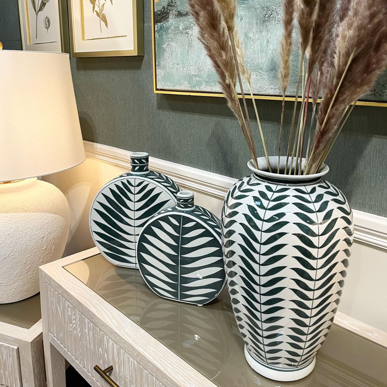 Leaf Bottle Small by Mindy Brownes This gorgeous ceramic decorative bottle will add a delicate pop of colour to your home. The calming colour pallet with it's green base and white leaf pattern will make this the perfect spring home accessory.