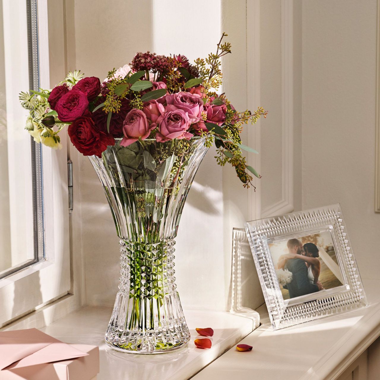 Lismore Diamond 14 in Vase by Waterford Crystal Perfect for displaying a floral bouquet or two dozen roses, this Lismore Diamond 14in Vase beautifully showcases its contents. The combination of its tall, 14in profile and enchanting flared rim enables cut flowers to stretch out into their surroundings, producing an eye-catching display of colour that breathes life into your home.