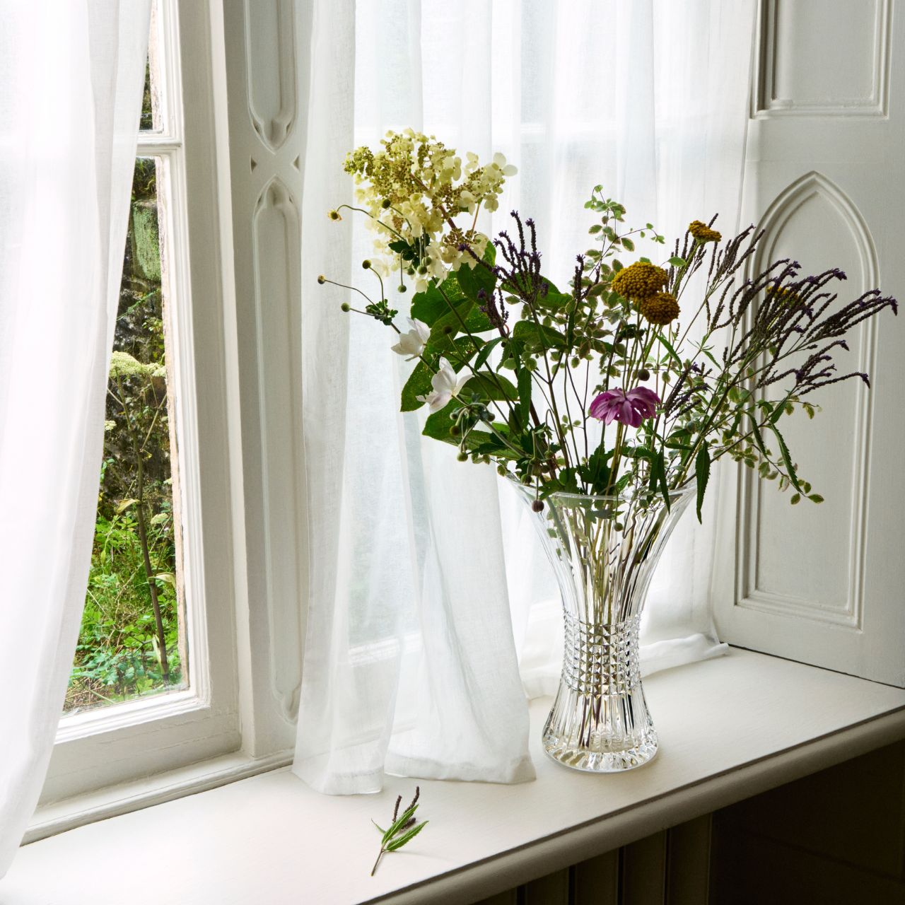 Lismore Diamond 14 in Vase by Waterford Crystal Perfect for displaying a floral bouquet or two dozen roses, this Lismore Diamond 14in Vase beautifully showcases its contents. The combination of its tall, 14in profile and enchanting flared rim enables cut flowers to stretch out into their surroundings, producing an eye-catching display of colour that breathes life into your home.
