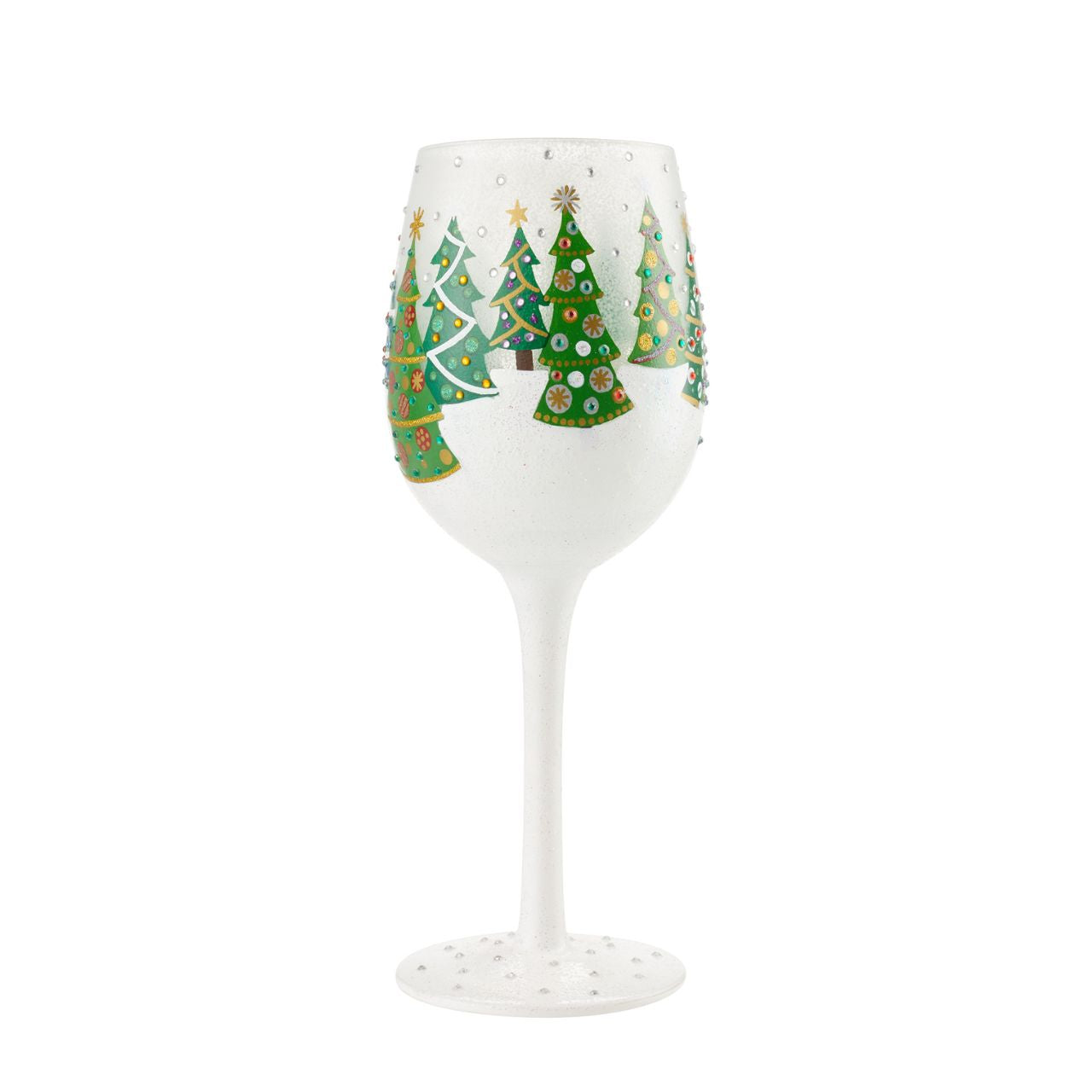 Christmas Trees in the Snow Wine Glass by Lolita  Christmas pines covered in lights and ornaments cover this winter wonderland wine glass. With textured snow and glittering accents, this wine glass is ready for wassail and snowflakes.