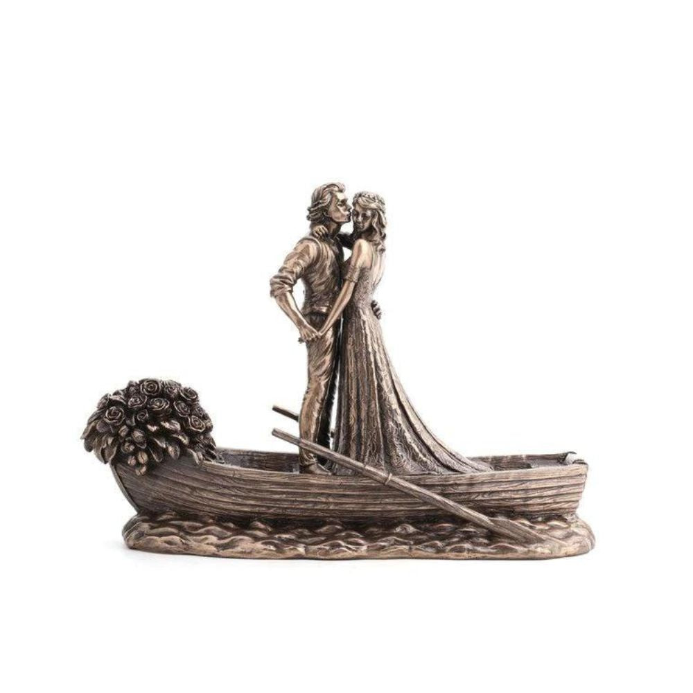 Love Boat by Genesis Ireland  A beautiful bronze coloured statue of a couple on their wedding day, sailing away in their love boat.  Perfect for art lovers or for an occasional gift such as a wedding or anniversary gift.
