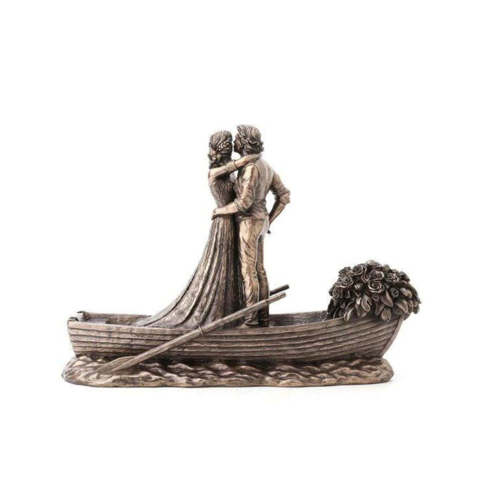 Love Boat by Genesis Ireland  A beautiful bronze coloured statue of a couple on their wedding day, sailing away in their love boat.  Perfect for art lovers or for an occasional gift such as a wedding or anniversary gift.