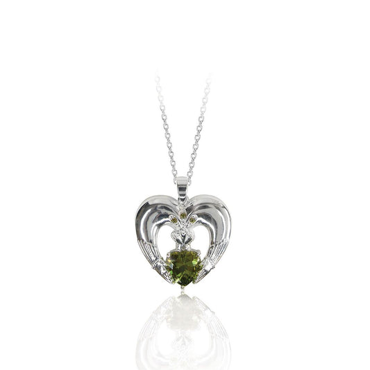 Celebrating love, loyalty and friendship, this heart-shaped Claddagh pendant shimmers. An emerald green heart-shaped stone is set at the center and adorned with a shimmering crown with three green crystal stone accents. This meaningful pendant will be cherished forever. Glistening with a bright polished ﬁnish, it suspends from a sleek linear bale and a cable chain with a 2” extension. It closes securely with a lobster claw clasp.