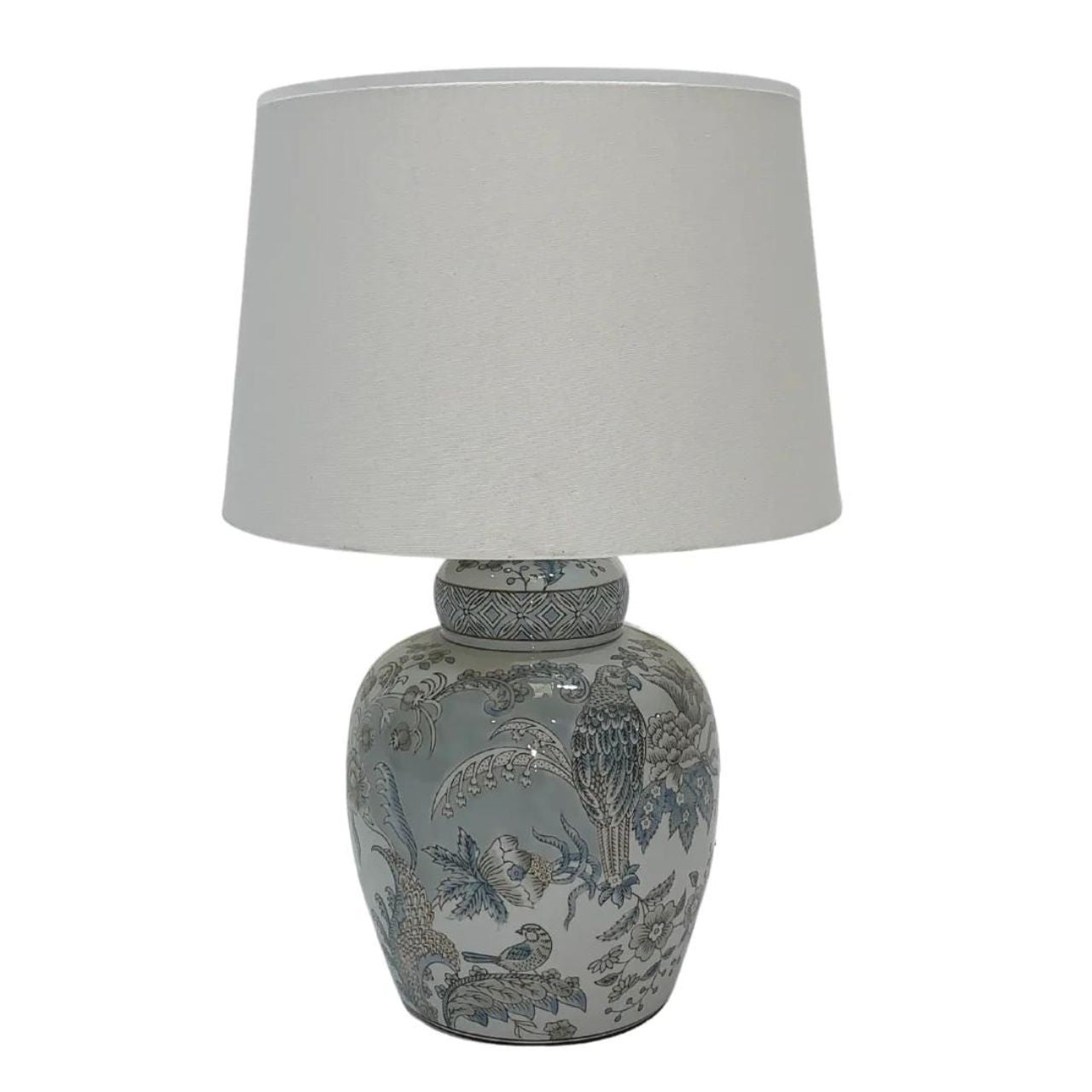 Mindy Brownes Delia Lamp Small Good lighting is essential for every home. Our ceramic collection is traditional yet timeless and featuring stunning designs, prints and patterns bursting with colour. This lamp in light blue and grey in colour. Tropical print design. A white linen shade.