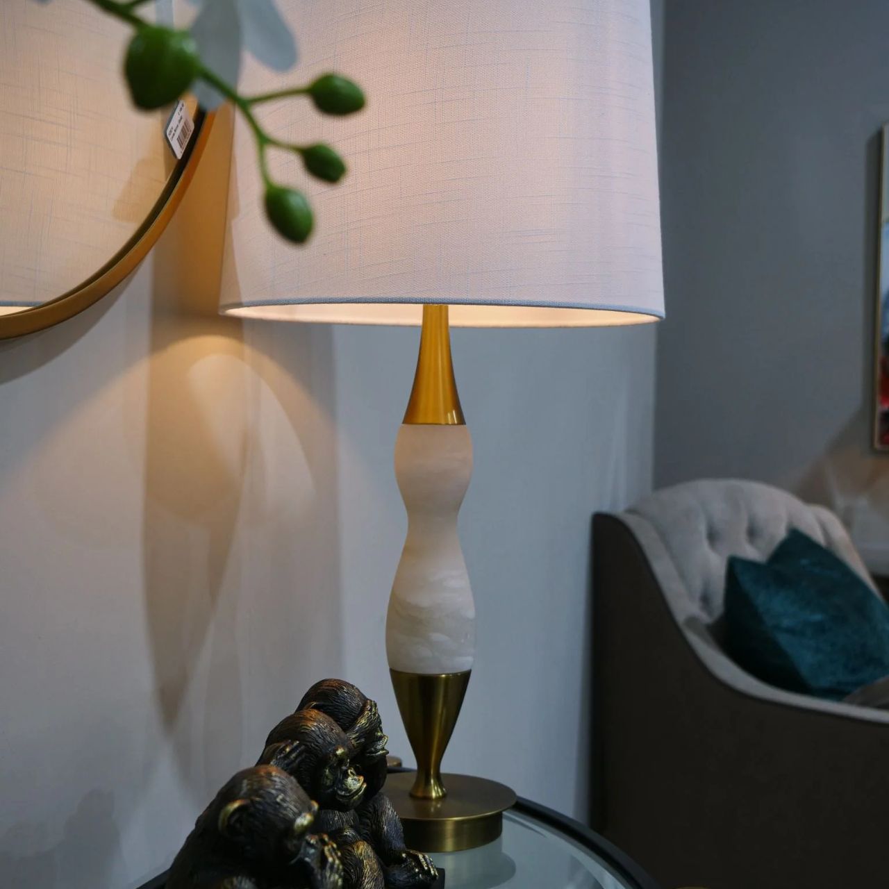 This lamp features white marble, brass accents, and a curved design. Ideal for those of you looking to add some softness to your home.