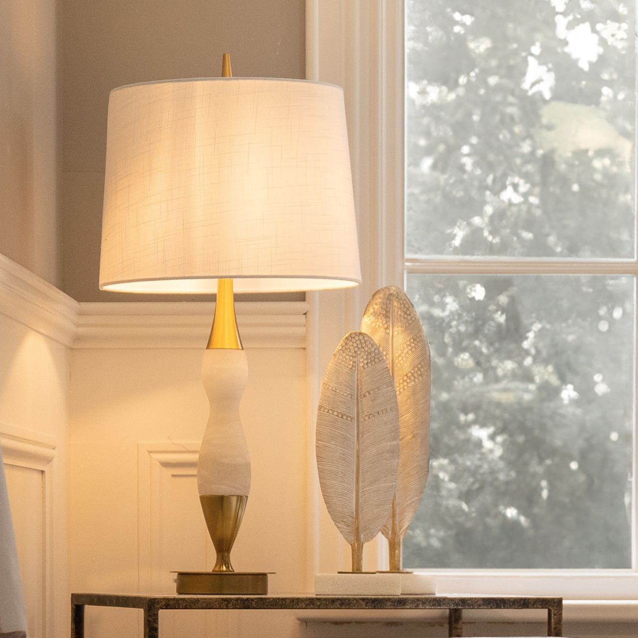 This lamp features white marble, brass accents, and a curved design. Ideal for those of you looking to add some softness to your home.