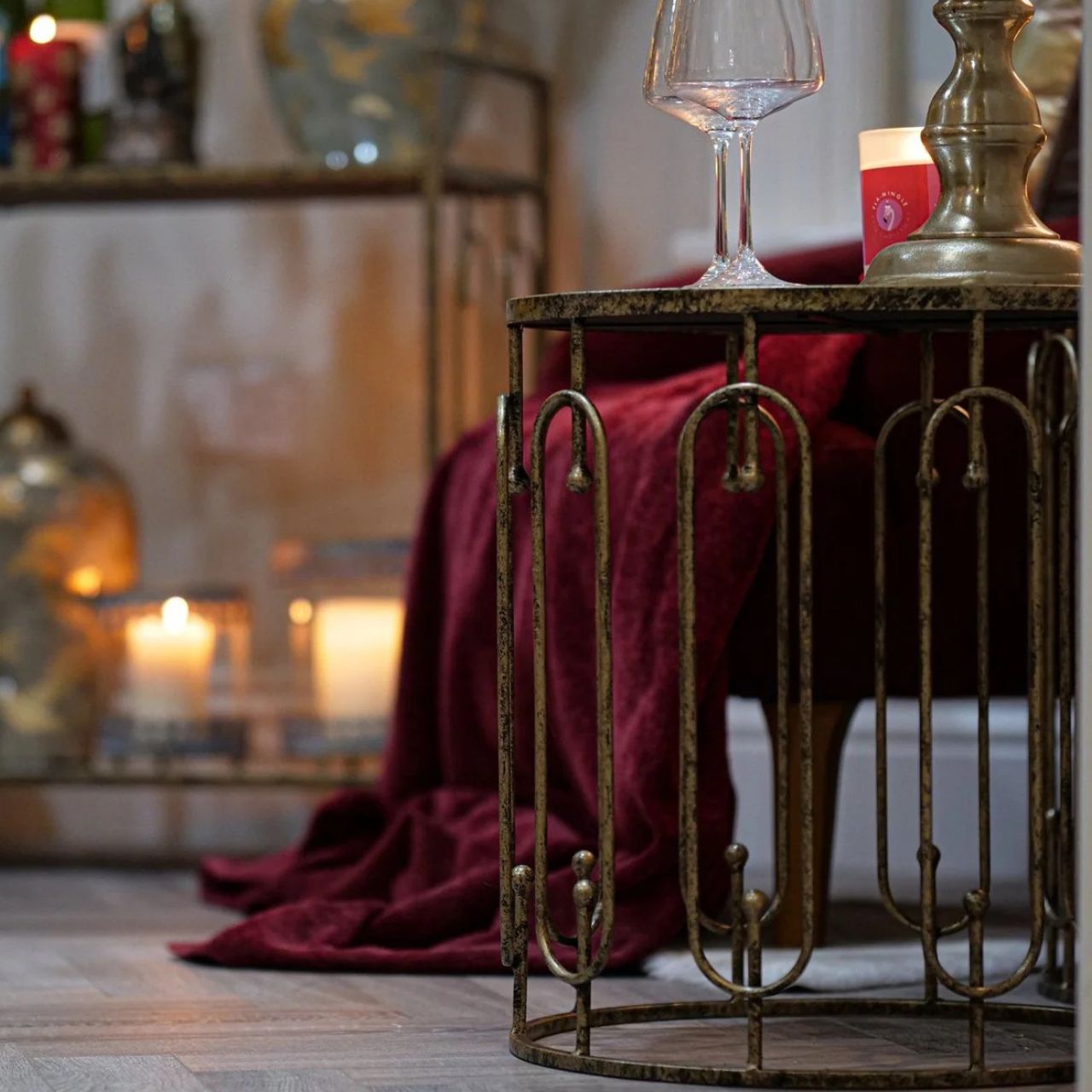 Two is always better than one. A beautiful set of two side tables that neatly stack on top of each other. Circular in design with oblong detailing on the outer surround. Finished with a mirrored top and distressed antique gold.